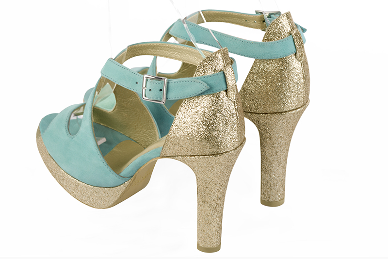 Aquamarine blue and gold women's closed back sandals, with crossed straps. Round toe. Very high slim heel with a platform at the front. Rear view - Florence KOOIJMAN
